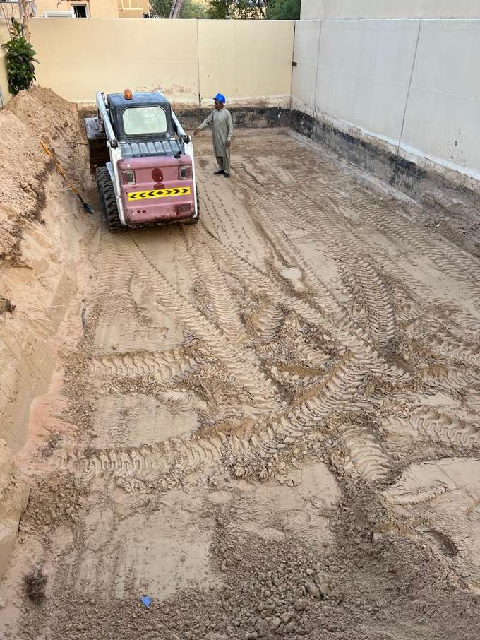 Skid-steer excavating the plot